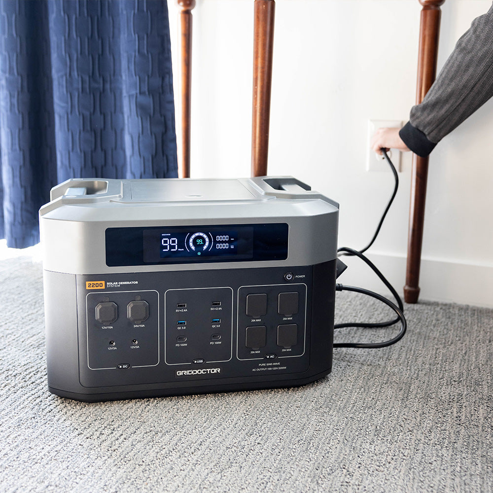 Depicts the 2200 battery on the floor of a home charging.