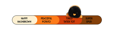 A Spudsters tarantula plush by Aurora that is placed at tired tater tot on the spud-o-meter