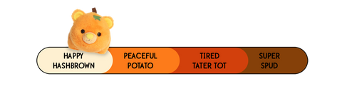 A Spudsters pumpkin bear plush by Aurora that is placed at happy hashbrown on the spud-o-meter